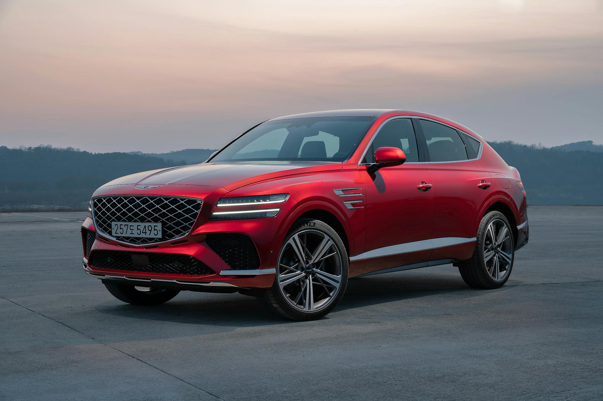 Sleek red luxury SUV at sunset
