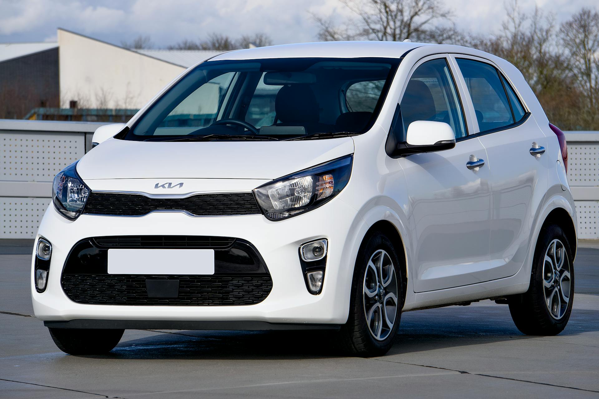 white compact kia hatchback