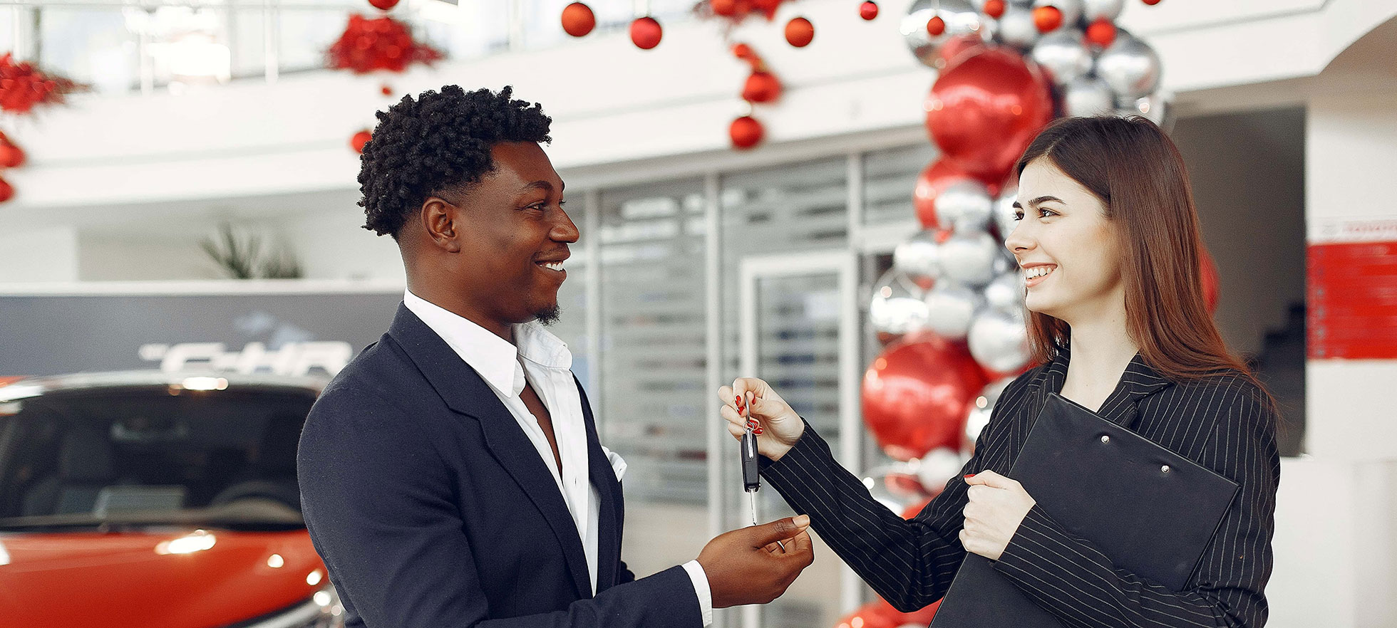 happy customer receiving new car keys