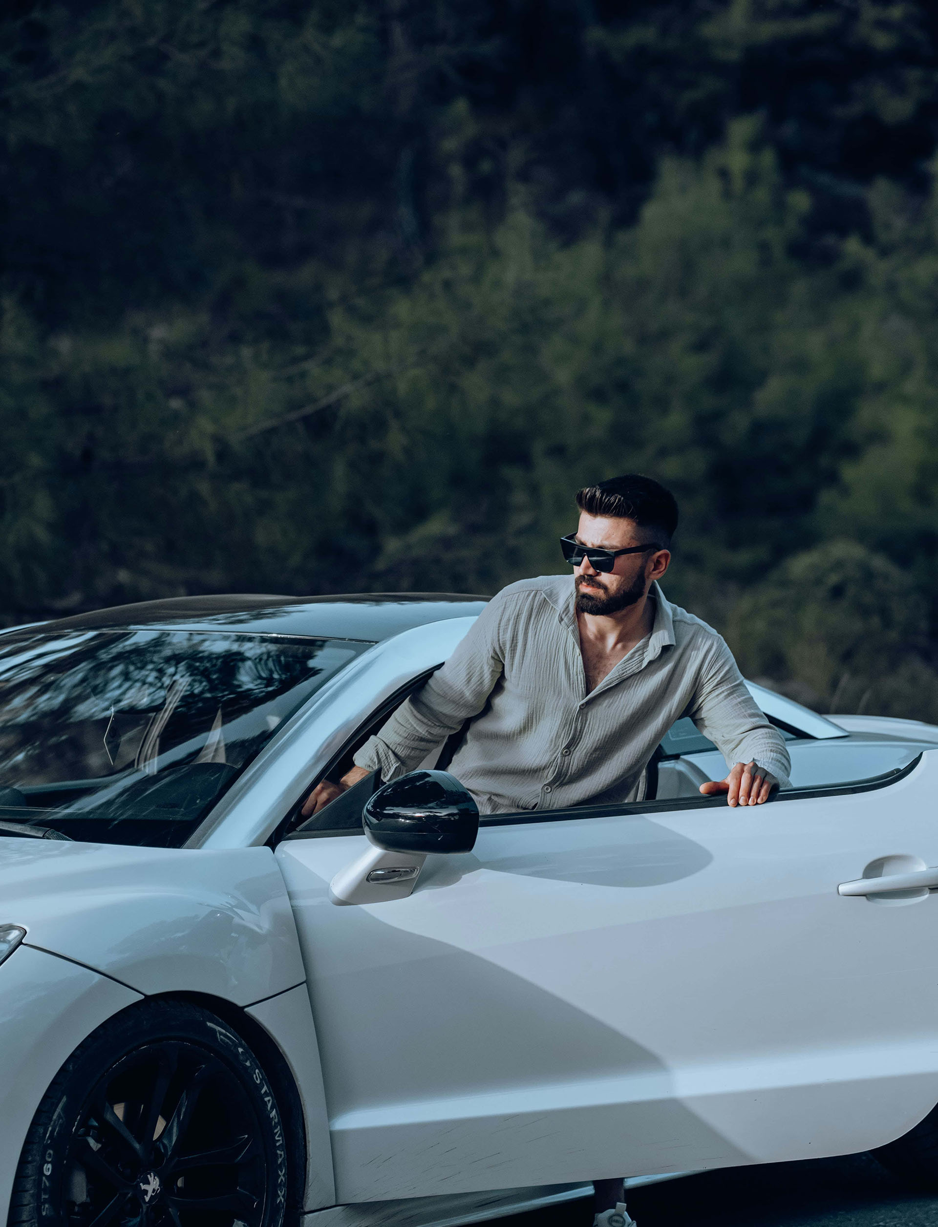 man stepping out of luxury car