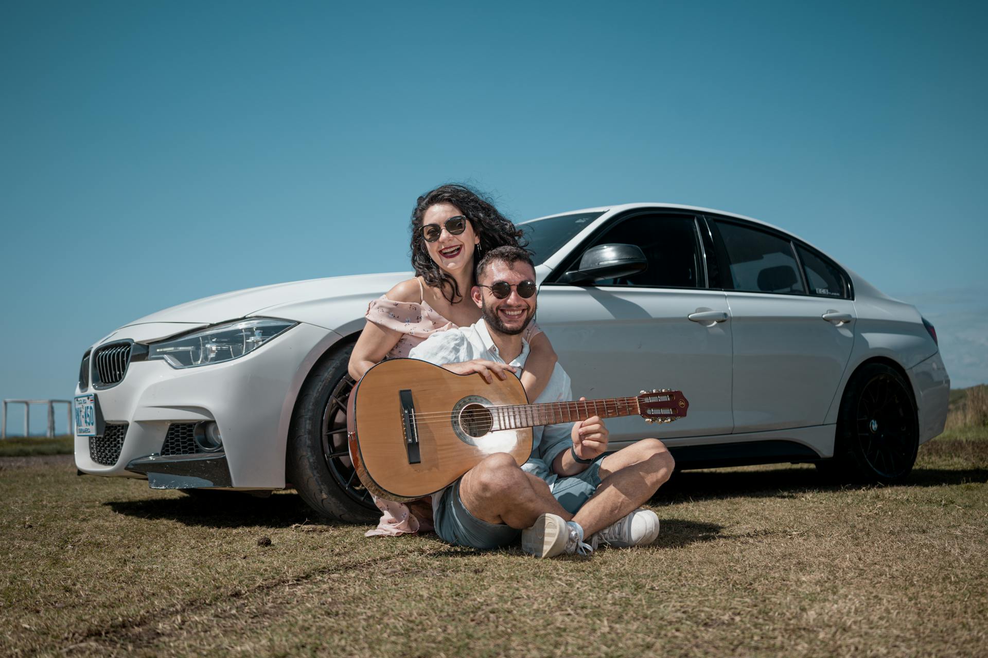 couple enjoying music beside car